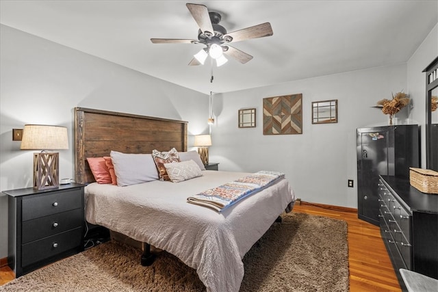 bedroom featuring light hardwood / wood-style flooring and ceiling fan