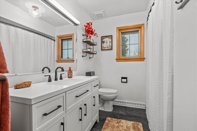 bathroom with tile patterned flooring, vanity, toilet, and baseboard heating