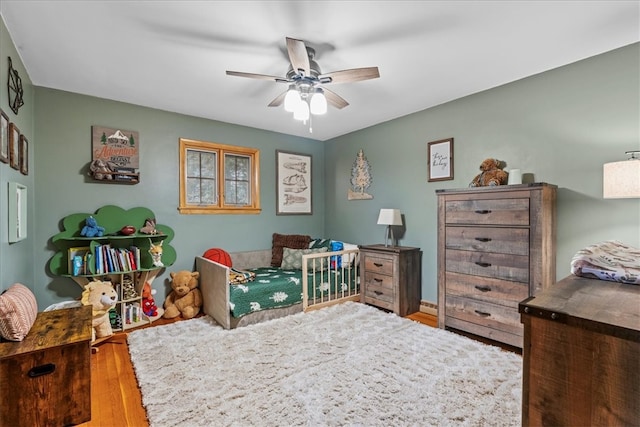 bedroom featuring hardwood / wood-style floors and ceiling fan