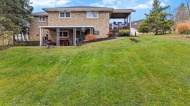 back of house featuring a yard and a wooden deck