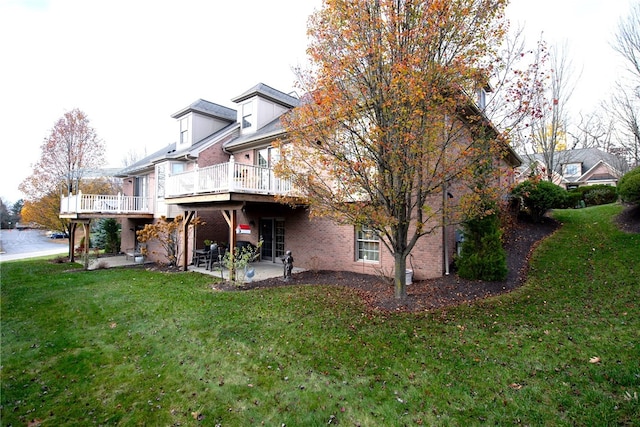 back of house featuring a patio, a deck, and a lawn