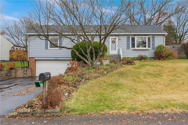 view of front facade with a garage and a front lawn