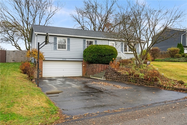 view of front of property with a garage and a front lawn