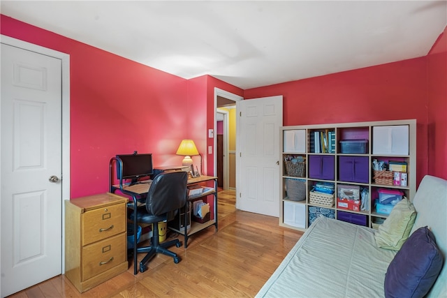 home office with light hardwood / wood-style flooring