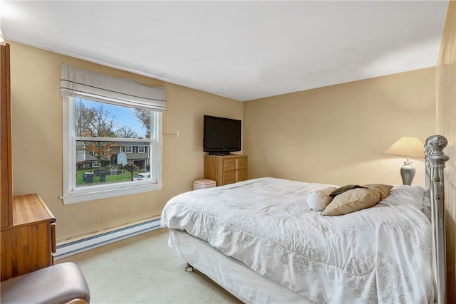 bedroom featuring baseboard heating and carpet flooring