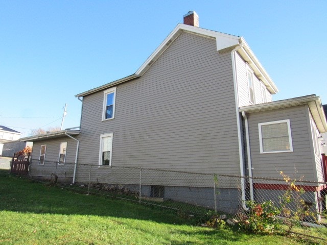 view of home's exterior with a yard