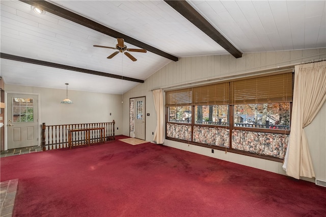 empty room with ceiling fan, carpet, and lofted ceiling with beams