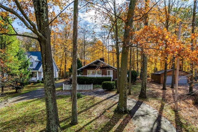 exterior space featuring an outbuilding, covered porch, and a garage