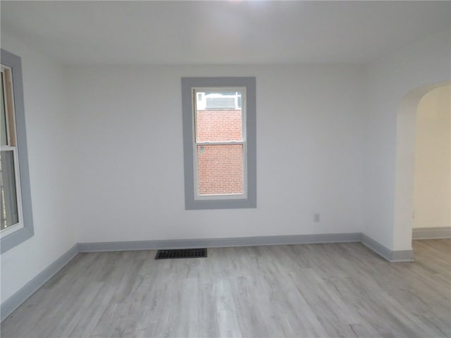 empty room with light hardwood / wood-style flooring