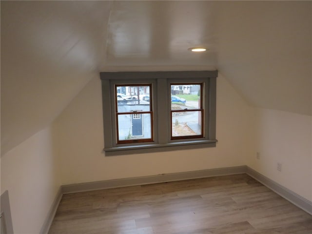 bonus room with light hardwood / wood-style floors and lofted ceiling