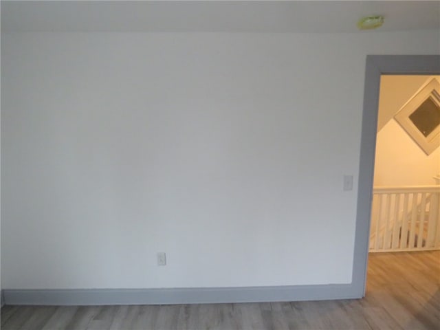 unfurnished room with light hardwood / wood-style floors