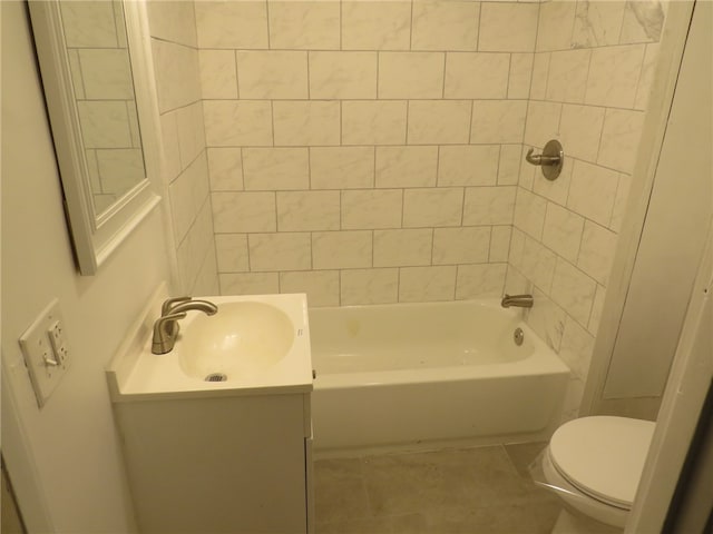 full bathroom with tile patterned flooring, vanity, toilet, and tiled shower / bath