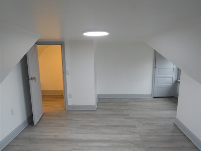 bonus room with light hardwood / wood-style floors