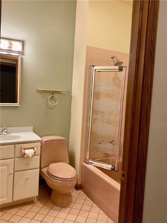 full bathroom with tile patterned floors, toilet, vanity, and combined bath / shower with glass door