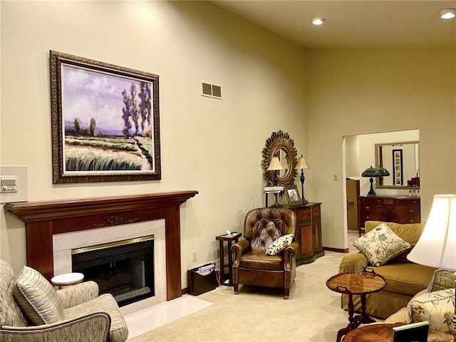 carpeted living room featuring lofted ceiling and a premium fireplace