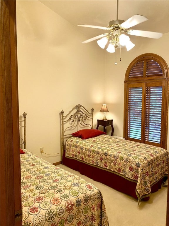 bedroom with carpet flooring, ceiling fan, and vaulted ceiling