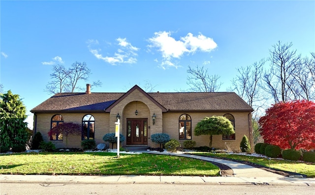 ranch-style house with a front lawn