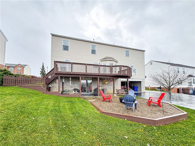 back of property featuring a lawn, a patio, and a wooden deck