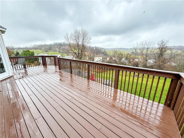 wooden terrace with a lawn