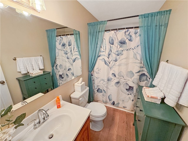 bathroom featuring a shower with shower curtain, vanity, wood-type flooring, and toilet