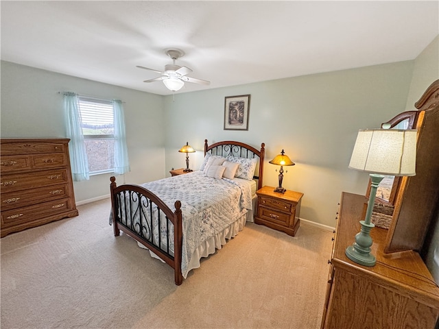 bedroom with ceiling fan and light carpet