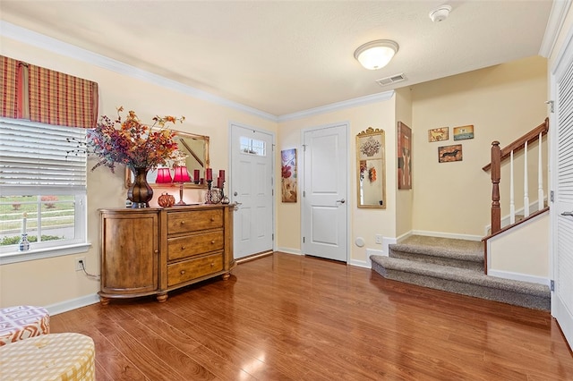 foyer featuring hardwood / wood-style floors and ornamental molding