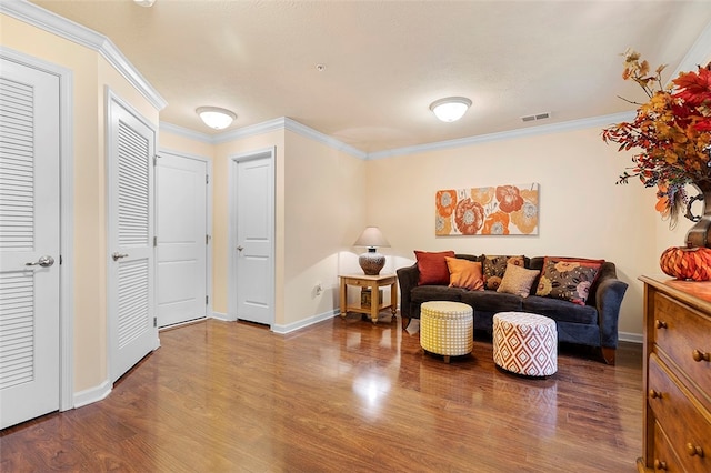 living room featuring hardwood / wood-style floors and crown molding