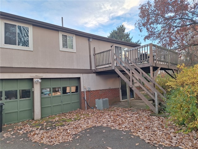 exterior space with a wooden deck and central AC