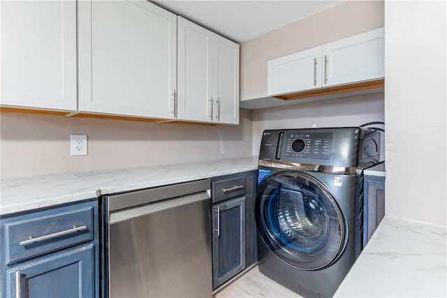 laundry area with washer / clothes dryer and cabinets