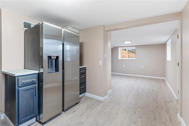 kitchen featuring stainless steel refrigerator with ice dispenser and light hardwood / wood-style flooring