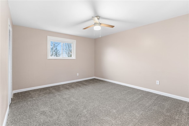 spare room with ceiling fan and carpet