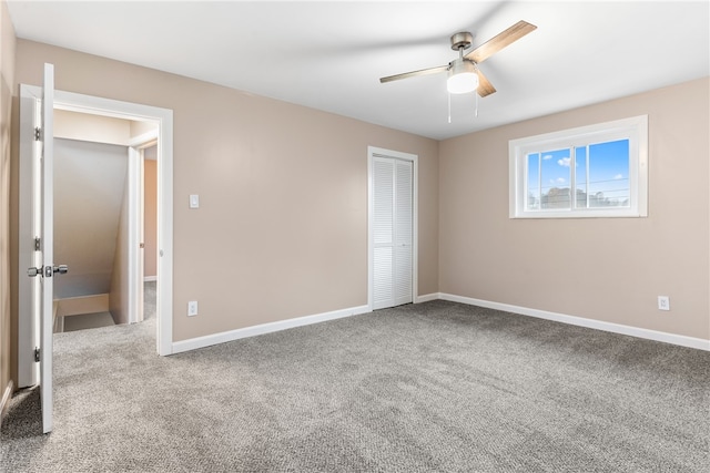 unfurnished bedroom featuring carpet flooring, ceiling fan, and a closet