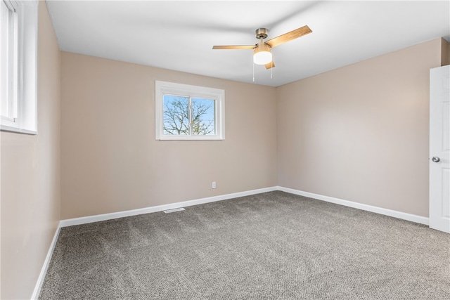 empty room featuring carpet flooring and ceiling fan