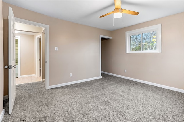 carpeted empty room with ceiling fan