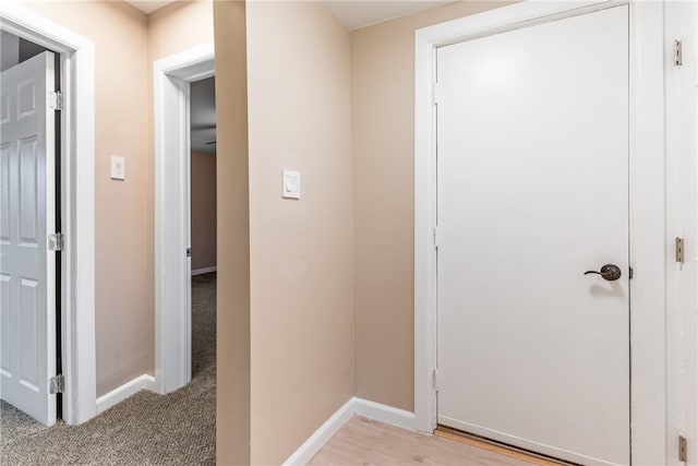 hallway with light hardwood / wood-style floors