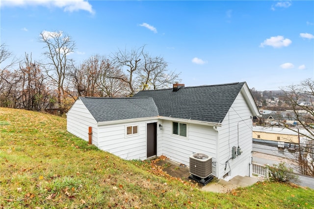 exterior space with a lawn and central AC unit