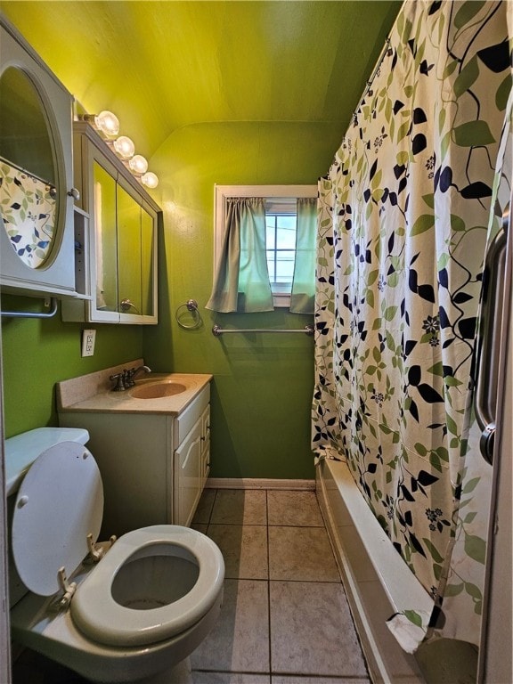 bathroom featuring vanity, tile patterned floors, walk in shower, and lofted ceiling