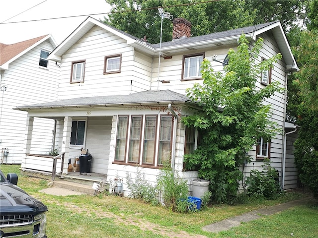 view of front of house featuring covered porch and a front lawn