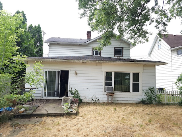 back of house featuring a yard, cooling unit, and a patio area