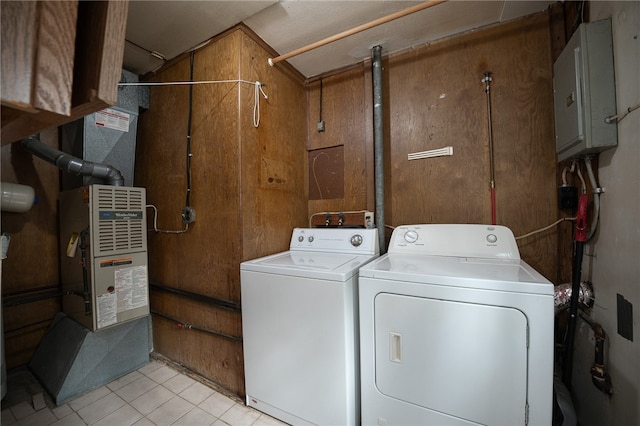 laundry area featuring wood walls and independent washer and dryer