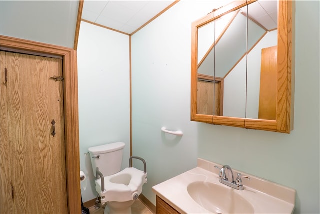 bathroom featuring vanity, ornamental molding, and toilet