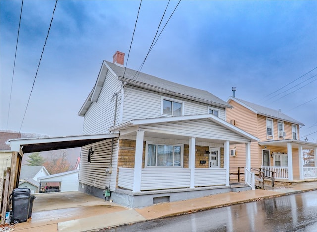 view of front of house with a carport and covered porch