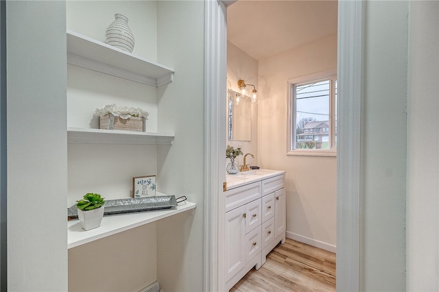 bathroom with hardwood / wood-style flooring and vanity