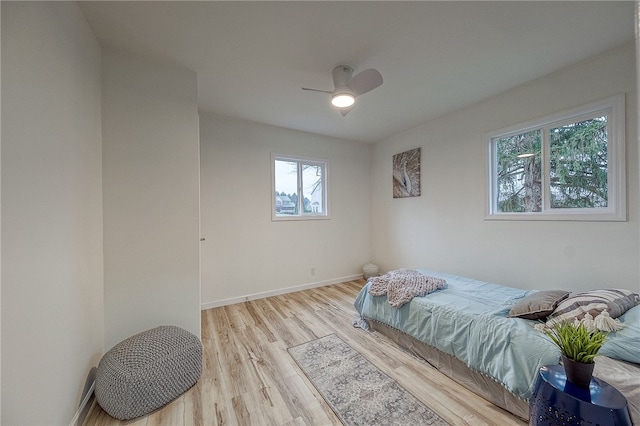 bedroom with ceiling fan and light hardwood / wood-style floors