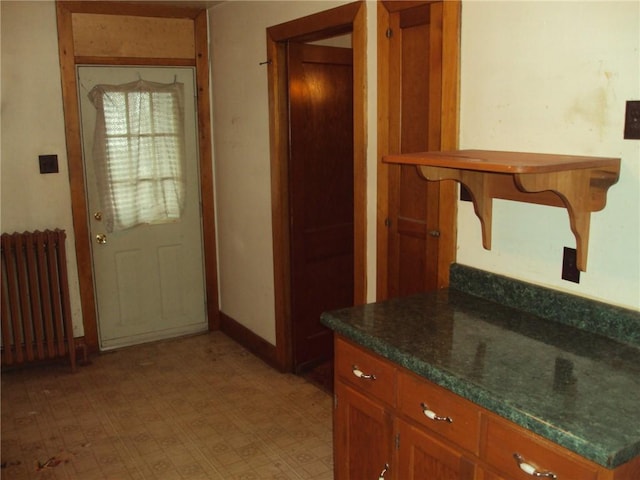 331 W Main, Somerset Boro, PA 15501 - kitchen featuring radiator heating unit, brown cabinets, light flooring, and dark countertops
