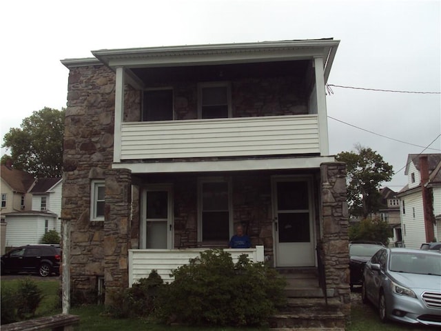 331 W Main, Somerset Boro, PA 15501 - townhome / multi-family property featuring stone siding, covered porch, and a balcony