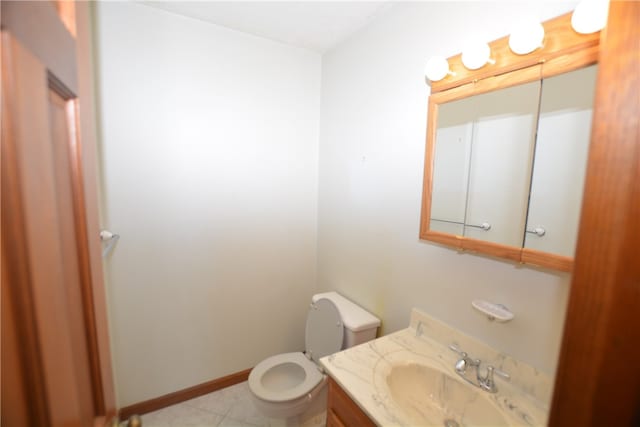 bathroom featuring tile patterned flooring, vanity, and toilet