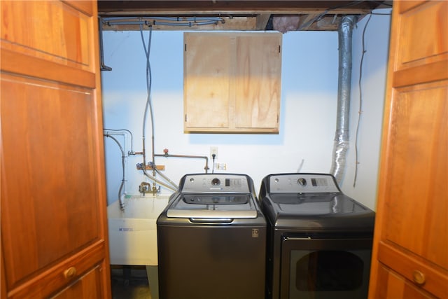 clothes washing area featuring sink and washer and dryer