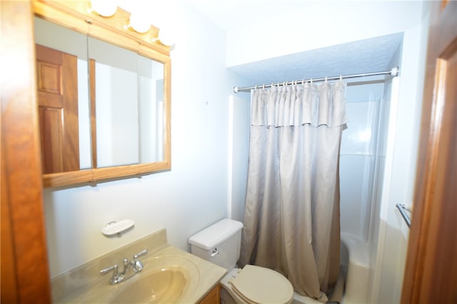 full bathroom with vanity, shower / bath combo, and toilet