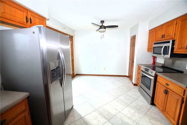 kitchen featuring ceiling fan, light tile patterned floors, and appliances with stainless steel finishes